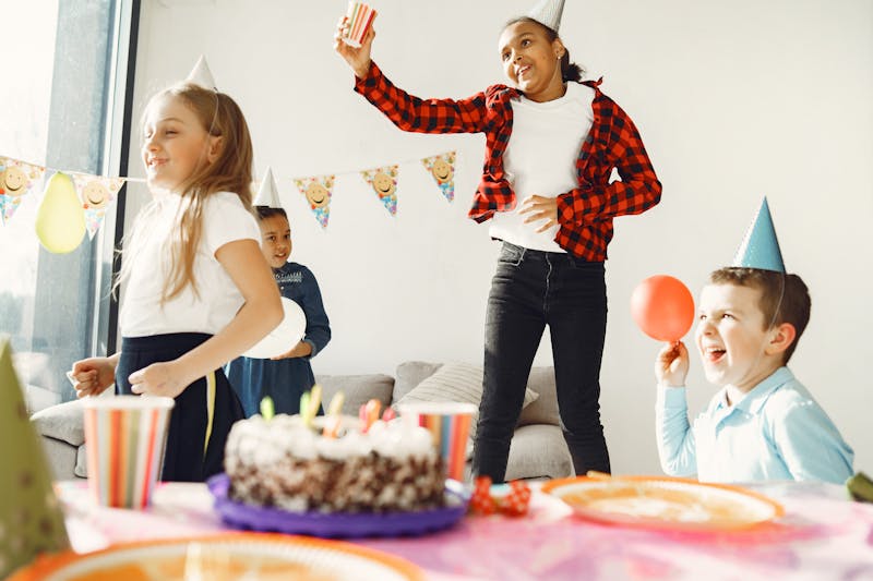 Children celebrating and dancing at a birthday party